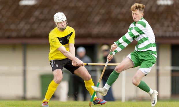 Oban Celtic's Daniel MacMillan tries to block the swing of Arran MacPhee (Fort). Image: Neil Paterson.