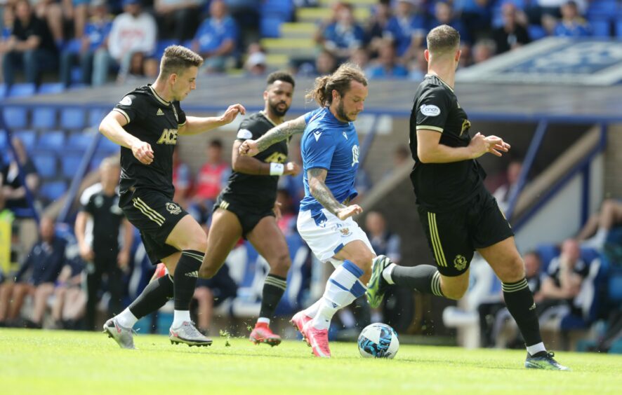 Stevie May tries to weave his way through the Cove defence