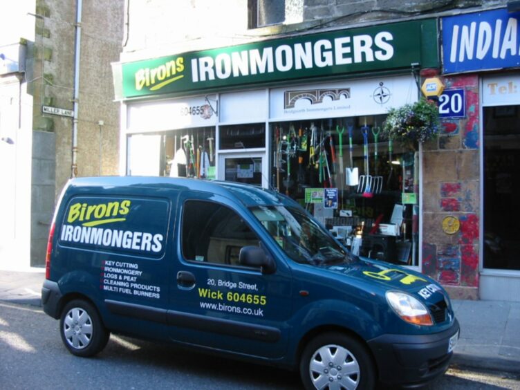 Car with Birons Ironmongers on its side.