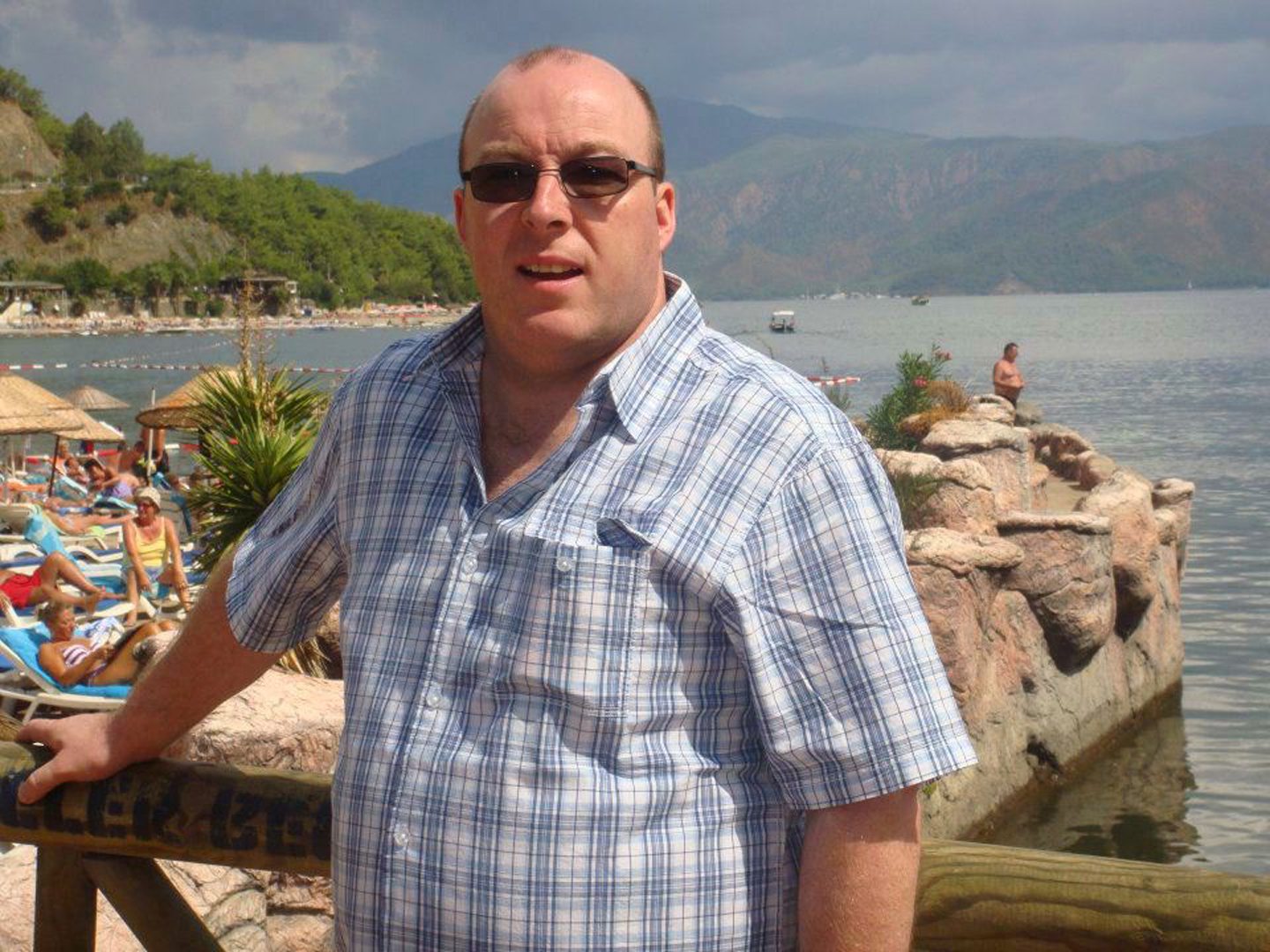 Ian Forbes shown on holiday wearing sunglasses.