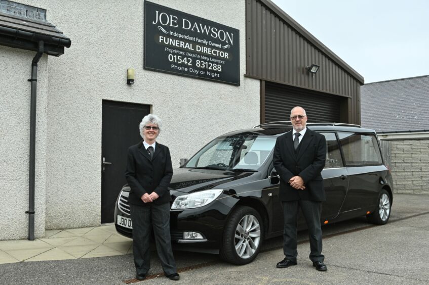 The Lawrences outside Joe Dawson funeral director premises, now up for sale.