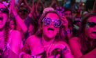 Belladrum music festival in the Highlands is about to get underway. Pictured is a woman in glasses enjoying the music at night.