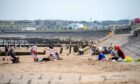 Crowds gathered on Aberdeen beach to enjoy the good weather while it lasts. Picture by Kath Flannery.