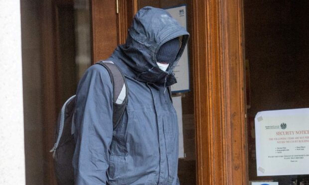 Daniel Tough hid his face as he left court.