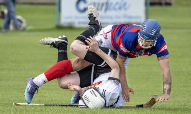 Getting in a tangle: Lovat's Graeme MacMillan with Kieran Macpherson (Kingussie).    Kingussie v Lovat in the Artemis MacAulay Cup semi final (North), played at Braeview, Beauly.