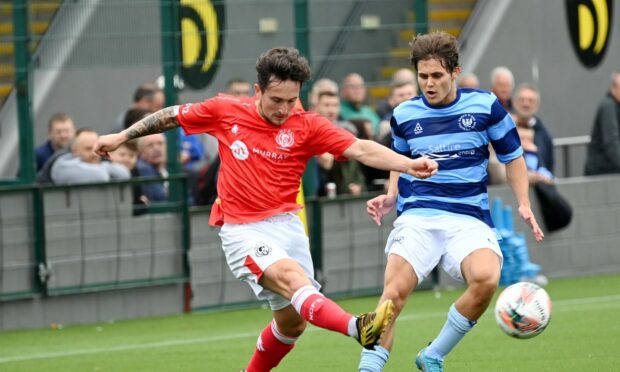 Nairn County's Andrew Greig, left, tries to get away from Magnus Watson of Banks o' Dee