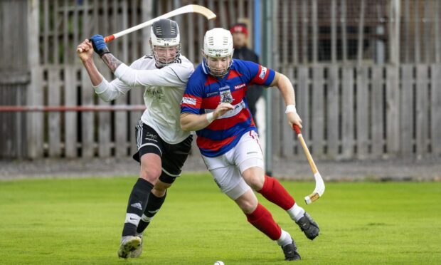 Samuel Stubbs, left, in action for Lovat with Rory MacKeachan (Kingussie).  Image: Neil Paterson.