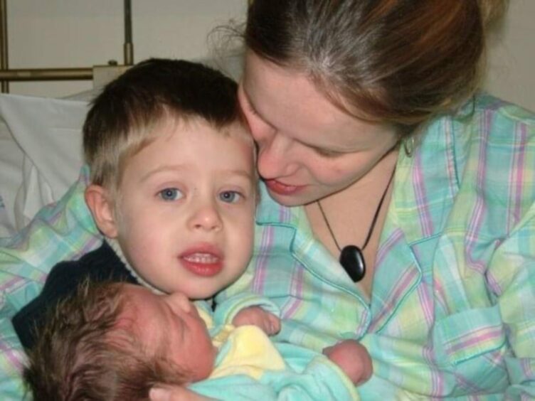 Lindsay introducing Corban to Micah when he was a newborn baby