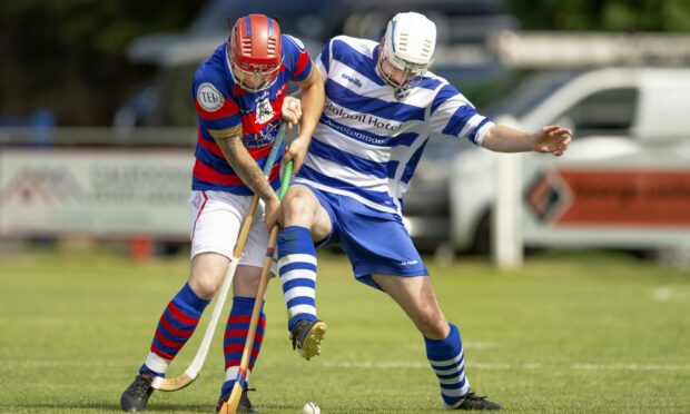 Newtonmore's Rory Kennedy, right, in action against Kingussie.
