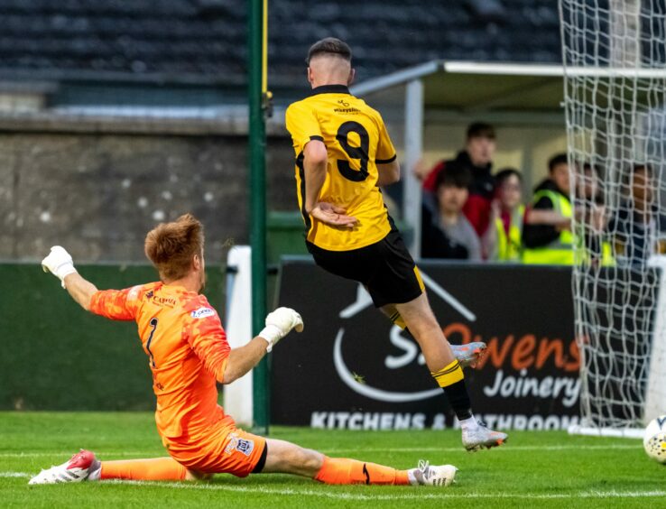Nairn County player scoring a goal.
