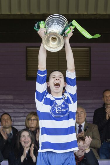 Newtonmore captain Rory Kennedy lifts the Camanachd Cup in 2017. Image: Neil G Paterson.