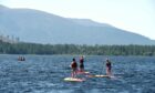 Paddleboarders on a loch.