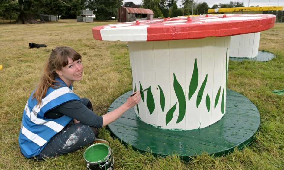 Freelance illustrator Claire Maclean of Inverness converting a cable drum into a toadstool for Belladrum. Photo: Sandy McCook/DC Thomson