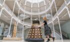 Member of staff Liv Mullen with a Dalek during a photocall at the National Museum of Scotland in Edinburgh for the announcement of the forthcoming Doctor Who Worlds of Wonder exhibition in December. Jane Barlow/PA Wire