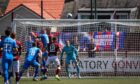 Caley Thistle striker Billy Mckay wins this header but it comes back off the post.