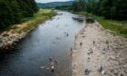 People enjoying cooling off in the River Dee at Potarch as temperatures soared across Aberdeenshire on July 19. Picture by Wullie Marr/DC Thomson.