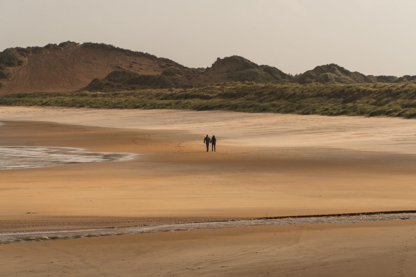 Couple walking on Fraserburgh beach