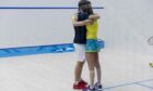 Greg Lobban and wife Donna embrace after their mixed doubles match.