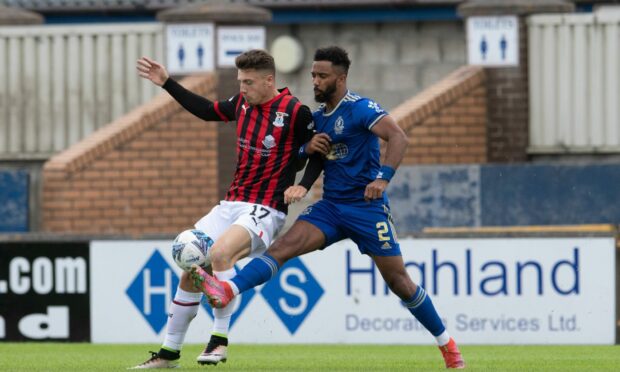 Caley Thistle's Daniel Mackay keeps the ball under pressure from Cove Rangers' defender Shay Logan.