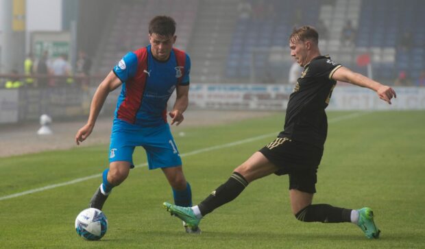 Caley Thistle's Lewis Hyde takes on Cieran Dunne of Cove Rangers