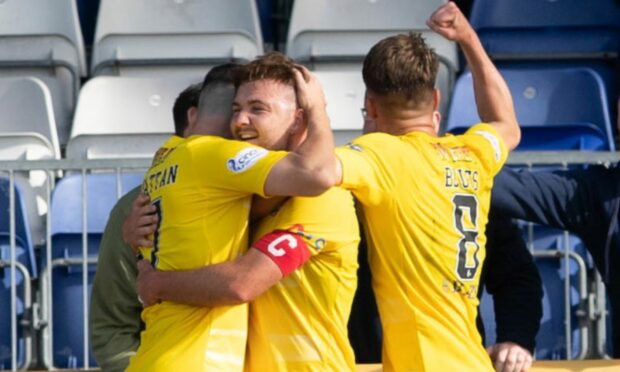 Morton's Grant Gillespie celebrates with team-mates after scoring the clinching penalty.