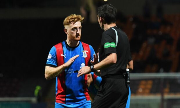 Caley Thistle midfielder David Carson is penalised by referee Kevin Clancy against Motherwell