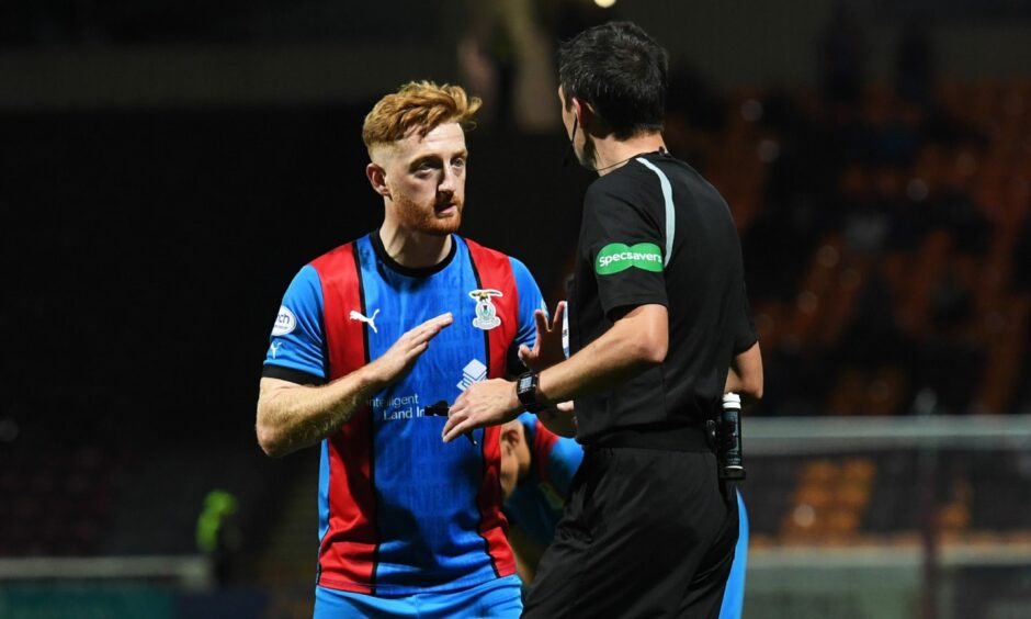 Caley Thistle midfielder David Carson is penalised by referee Kevin Clancy against Motherwell