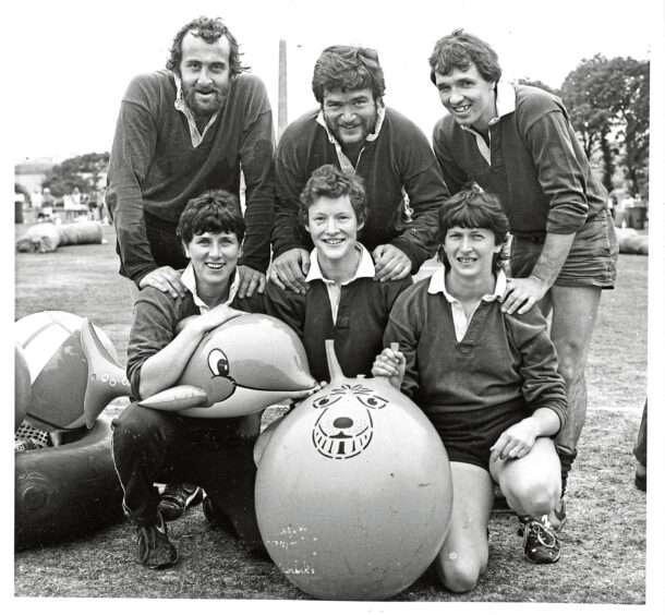 A group of rugby players with a space hopper and an inflatable dolphin at It's a Knockout