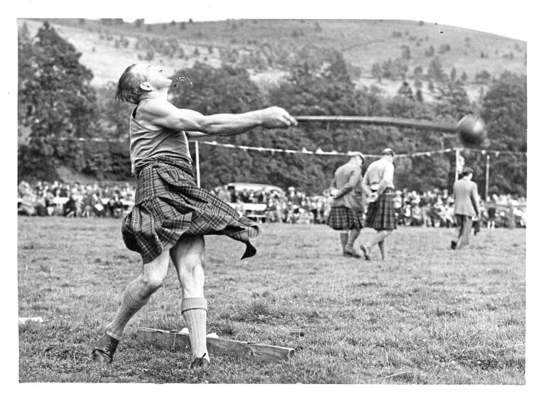 A man taking part in the hammer event at the Lonach Gathering