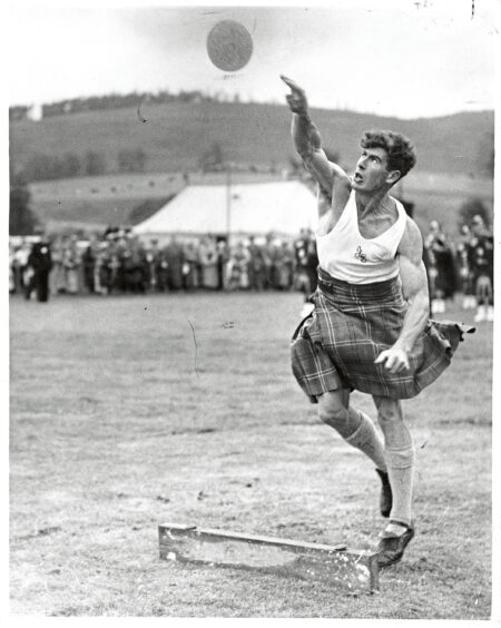 A man throwing the heavy stone a the Lonach Games