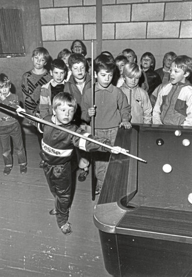 1986 - Derek Miller, 6, takes a shot in the final of the under-12s Tillydrone Community Centre pool competition 