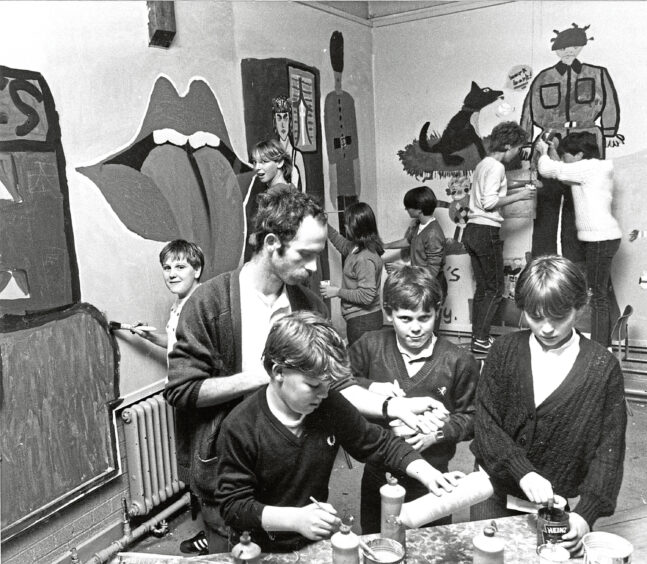 1983 - Nick Garry advises Brian Millar, 14, his brother Colin, 12, and Leigh Taylor, 11, working on mural art as part of the Aberdeen Alternative Music Festival fringe