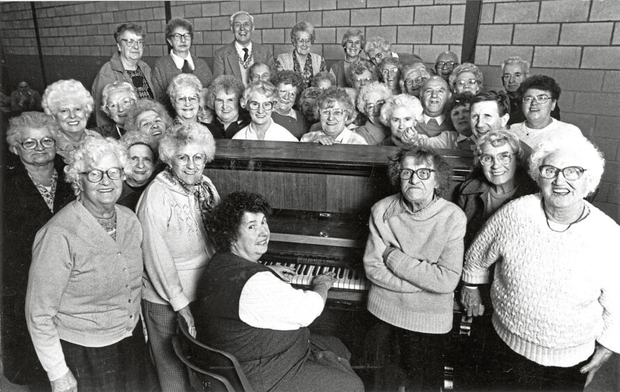1989 - Members of the Tillydrone Pensioners Club gather around Ruby Harmon at the piano for a singalong at their weekly meeting at the community centre.
