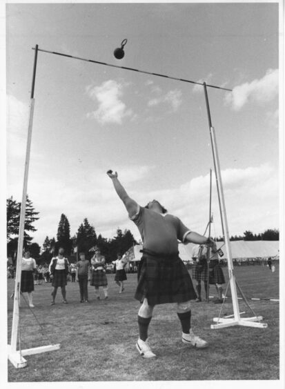 1983- Hamish Davidson, Nairn, clears the bar with ease in the 28lb. weight competition.
