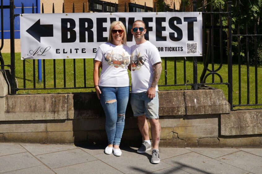 Inverurie Brew Fest organisers standing in front of a Brew Fest sign