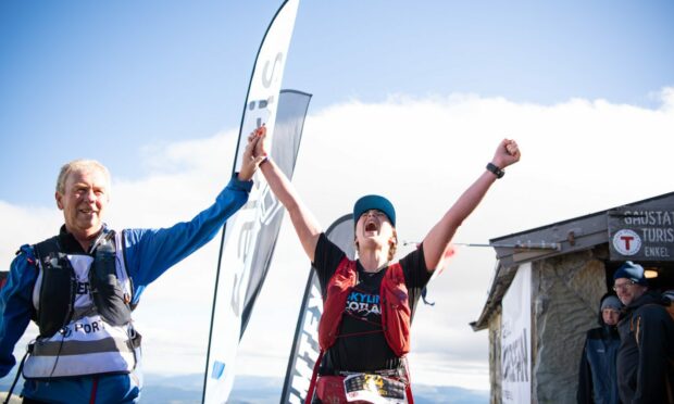 Eilidh Prise at the Norseman finish line with her dad, who was her support runner.(Photo by by Lars-Erik Blenne Lien / nxtri.com)