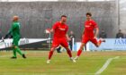 Brora's Tony Dingwall, centre, celebrates with Gregor MacDonald, right, after giving the Cattachs the lead against Banks o' Dee