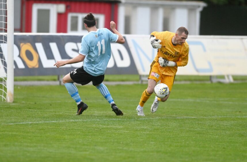 Deveronvale forward Kyle MacKillop-Hall nearly catches Formartine goalkeeper Ewen Macdonald in possession.