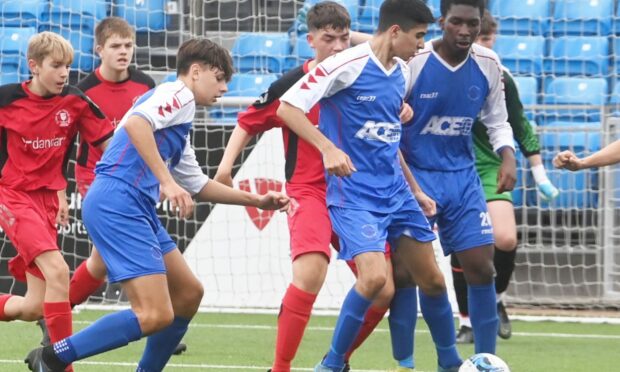 Cove YFC (blue) and Culter Colts (red) in action at Balmoral Stadium.  Pictured are Cove YFC's (blue) Oliver Najkowski and Seid Mody. Pic by Chris Sumner