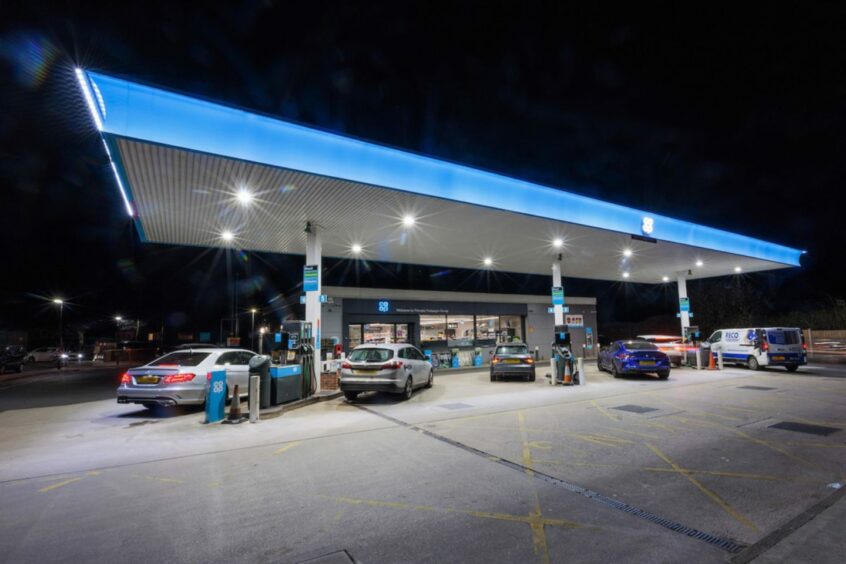 Co-op petrol forecourt at night.