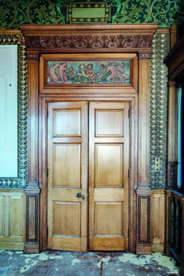 Inside the old bank: Note the decorative mural above the door.