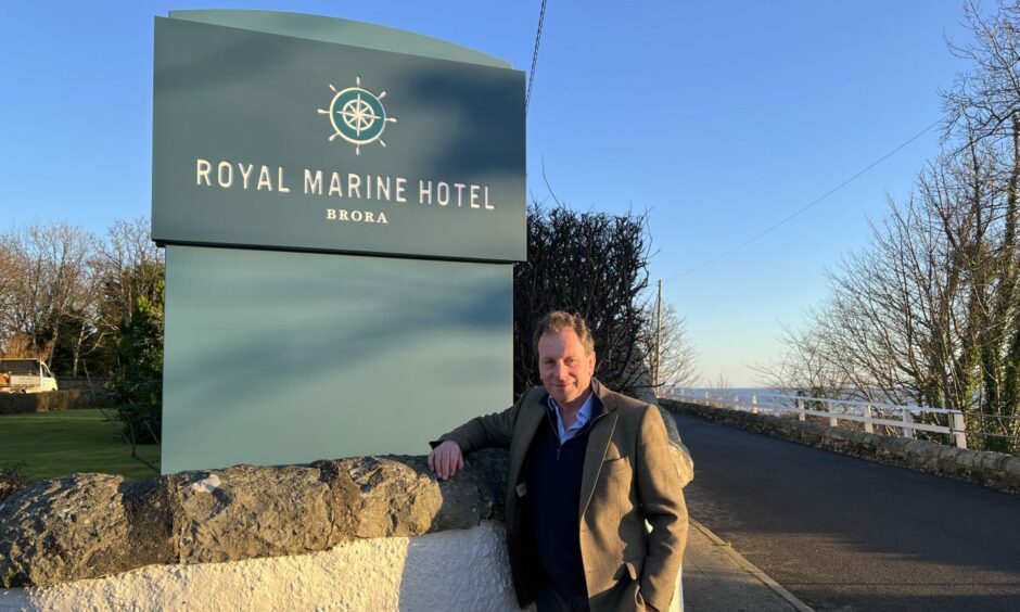 Highland Coast Hotels chairman David Whiteford standing in front of Royal Marine Hotel sign
