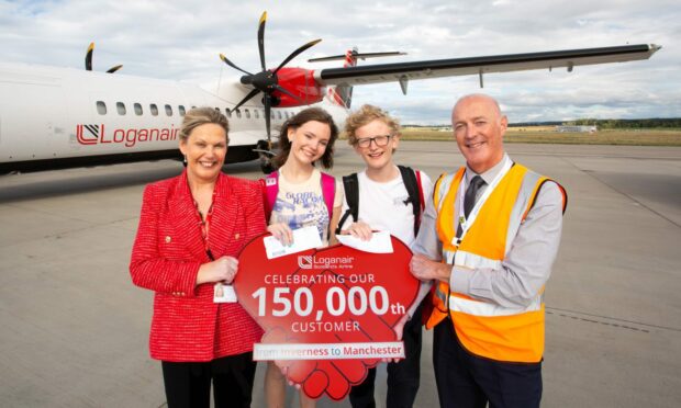 Twins Archie and Florrie Gray with their prize. Picture supplied by Loganair.