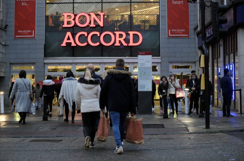 Shoppers walking in and out of the Bon Accord Centre on Black Friday