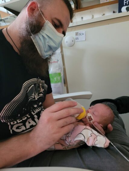 Christopher feeds baby Evie in the Aberdeen neonatal unit. 