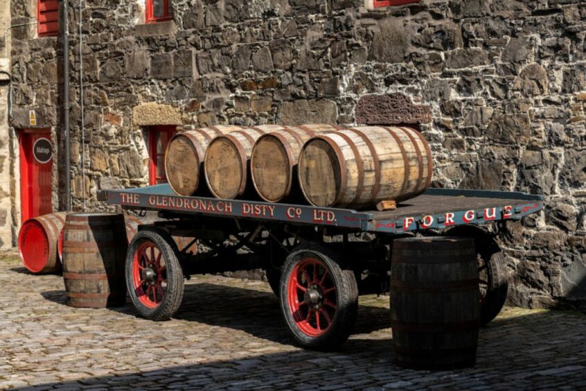 Barrels of The GlenDronach whisky on an old-fashioned cart.