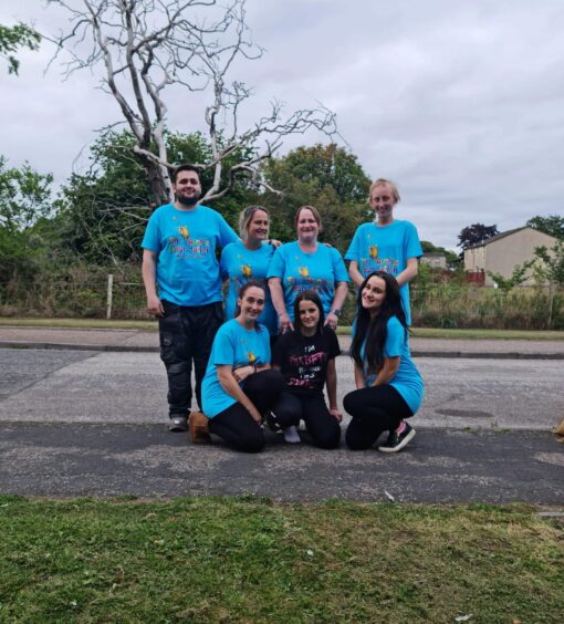 Lucy's family standing with their fundraising t-shirts on during one of their walks in Laurencekirk 