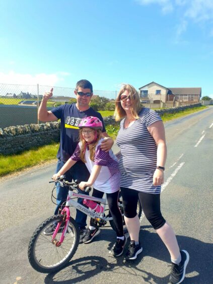 Indie Newlands finishes her last cycle as part of her fundraiser in honour of sister Aylee Nicolson. She is joined by her parents Wayne Nicolson and Shavonne Smith.