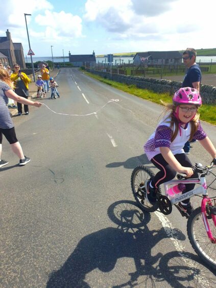 Indie Newlands finishes her last cycle as part of her fundraiser in honour of sister Aylee Nicolson.