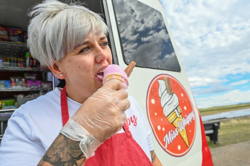 Amy eating a cone of ice cream from her Miss Whippy ice cream van